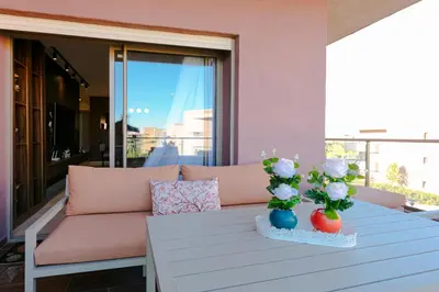 a living room with a couch and flowers on a table at Crystal Luxury Marrakech Prestigia in Marrakech
