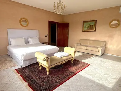 a bedroom with a bed and a couch and a chair at Palais Bahida in Marrakech
