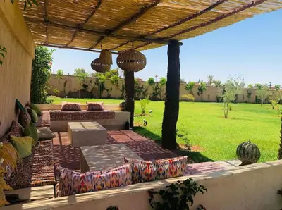 a patio with a pergola and a grass field at Villa 4 chambres sans vis à vis in Marrakech