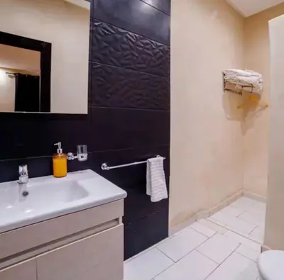 a bathroom with a white sink and a mirror at Villa 4 chambres sans vis à vis in Marrakech