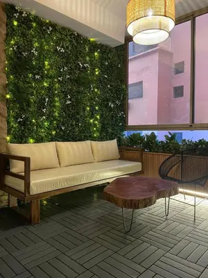 a living room with a couch and a green wall at Comfy space in Marrakech