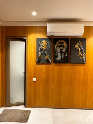 a room with pictures on the wall and a door at Comfy space in Marrakech