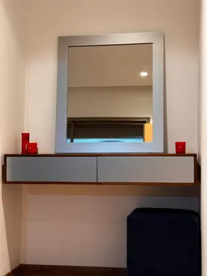 a mirror on a wall above a dresser in a bathroom at Comfy space in Marrakech