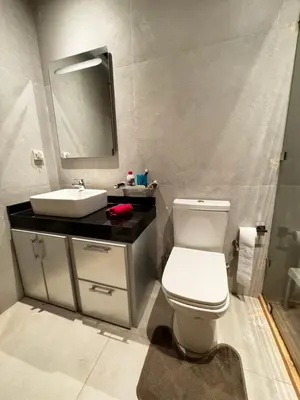 a bathroom with a white toilet and a sink at Comfy space in Marrakech