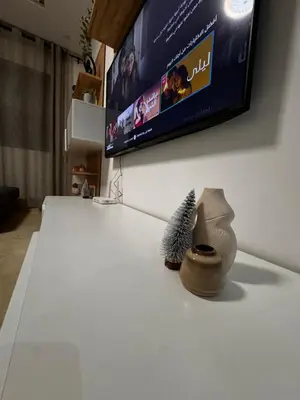 a living room with a tv and some items on a table at Cossy Inn in Marrakech