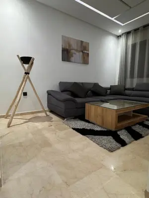 a living room with a couch and a coffee table at Cossy Inn in Marrakech
