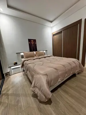 a bedroom with a large bed with a large bedspread at Cossy Inn in Marrakech