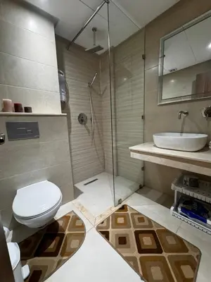 a bathroom with a toilet and a sink and a shower at Cossy Inn in Marrakech