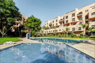a large swimming pool in front of a building at Appartement 5 piscine sport in Marrakech