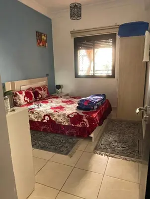 a bedroom with a bed and a window at Appartement 5 piscine sport in Marrakech