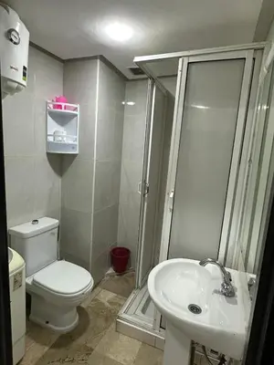 a bathroom with a toilet and a shower and a sink at le familial vous attend a L'Hivernage face Gare CTM in Marrakech
