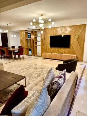 a living room with a couch and a flat screen tv at Plaza Guéliz Prestige Apartment in Marrakech