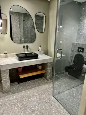 a bathroom with a sink and a glass shower at Plaza Guéliz Prestige Apartment in Marrakech