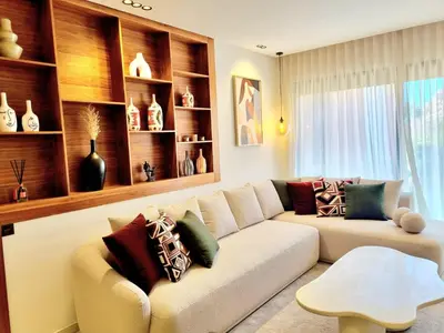 a living room with a couch with pillows on it at Stylish Marrakech getaway in Marrakech