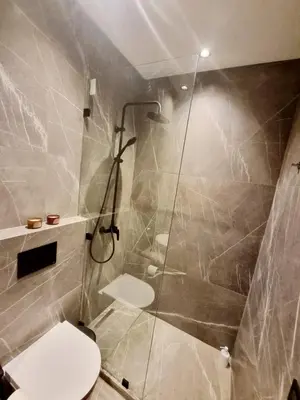 a bathroom with a shower and a toilet in it at Stylish Marrakech getaway in Marrakech