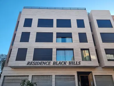 a tall building with the sign for resistance black hills at Stylish Marrakech getaway in Marrakech