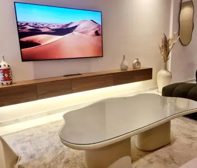 a living room with a white table and a flat screen tv at Stylish Marrakech getaway in Marrakech