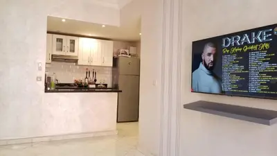 a kitchen with a menu on the wall and a counter at Appartement bijoux à gueliz in Marrakech