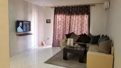 a living room with a couch and a coffee table at Appartement bijoux à gueliz in Marrakech
