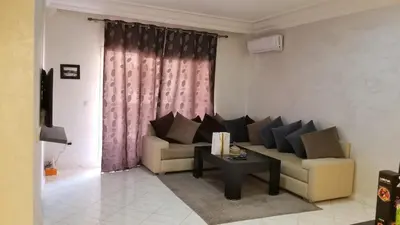 a living room with a couch and a table at Appartement bijoux à gueliz in Marrakech