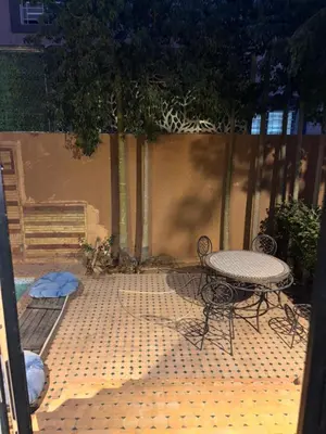 a table and chairs sitting on a tiled patio at Appartement dans villa jacuzzi in Marrakech