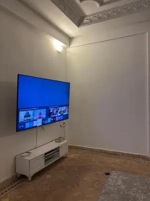 a living room with a large flat screen tv on a wall at Appartement dans villa jacuzzi in Marrakech