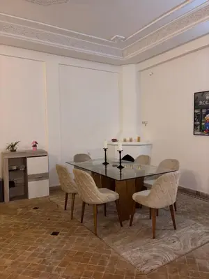 a dining room with a table and chairs at Appartement dans villa jacuzzi in Marrakech