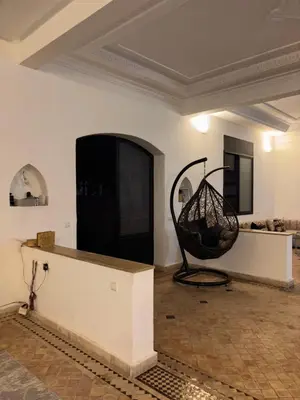 a living room with a large room with a swing at Appartement dans villa jacuzzi in Marrakech