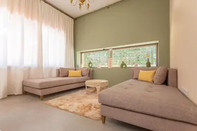 a living room with two couches and a window at Villa 5 Suites Modern with Ping Pong table and Heated Swimming pool in Marrakech