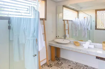 a bathroom with a sink and a mirror at Villa 5 Suites Modern with Ping Pong table and Heated Swimming pool in Marrakech