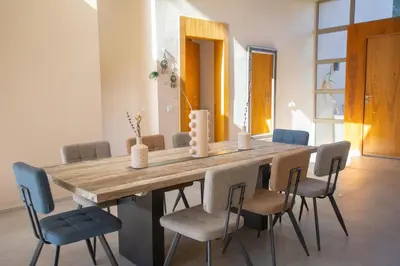 a dining room with a wooden table and chairs at Villa 5 Suites Modern with Ping Pong table and Heated Swimming pool in Marrakech