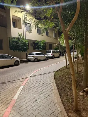 a street with cars parked on the side of the road at Appart Abir2 N1 Confort Au Centre-ville in Marrakech