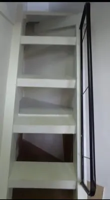 a closet with white shelves and a mirror at Chambre individuelle in Marrakech