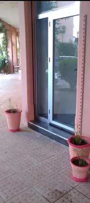 two potted plants sitting in front of a door at Chambre individuelle in Marrakech