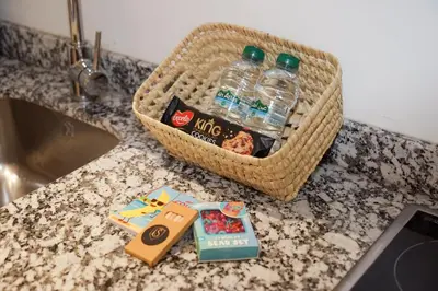 a basket of water bottles on a counter next to a sink at Cosy cocon au coeur de Gueliz-Parking gratuit in Marrakech