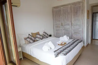 a bedroom with a large white bed with pillows at Cosy cocon au coeur de Gueliz-Parking gratuit in Marrakech
