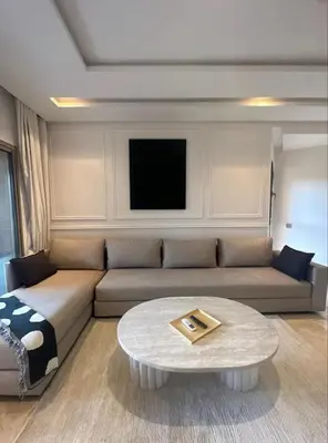 a living room with a couch and a coffee table at Ali plaza marrakech in Marrakech