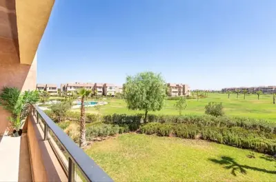 a balcony with a view of a park at Ali plaza marrakech in Marrakech
