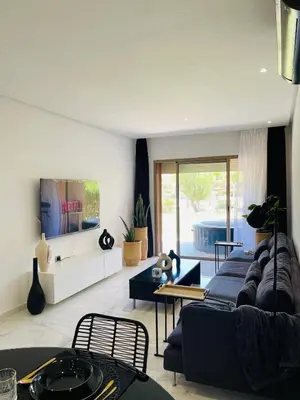 a living room with a couch and a table at Appartement Marrakech golfe in Marrakech