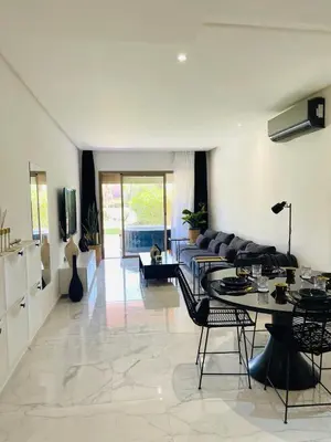 a living room with a couch and a table at Appartement Marrakech golfe in Marrakech