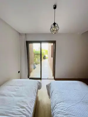 a bedroom with a bed and a view of a hallway at Appartement Marrakech golfe in Marrakech