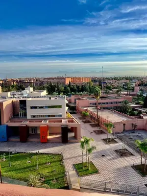 a view of a city with buildings and palm trees at Marrastay in Marrakech