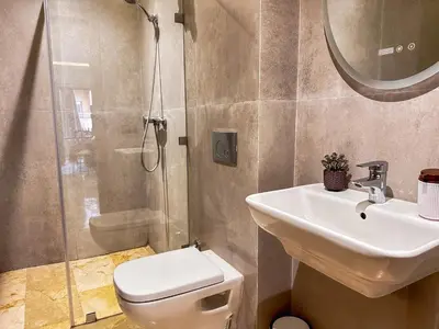 a bathroom with a toilet and a sink and a shower at Appartement cosy Marrakech in Marrakech
