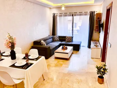 a living room with a couch and a table at Appartement cosy Marrakech in Marrakech