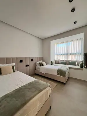 a bedroom with two beds and a window at Villa Tagana in Marrakech