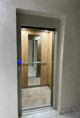 a glass door with a mirror in a building at La Citrine appartement de haut standing in Marrakech