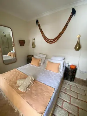 a bedroom with a large bed with a mirror at Riad Bacha Beldi in Marrakech