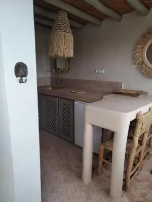 a kitchen with a white table and some chairs at Riad Bacha Beldi in Marrakech