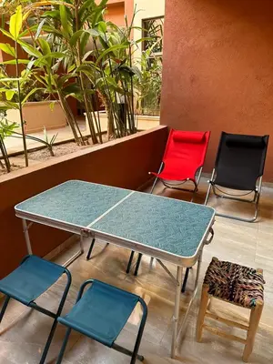 a table and four chairs in a room with a table at le saphir un appartement de paradis in Marrakech