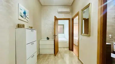 a room with a white dresser and a bedroom at le saphir un appartement de paradis in Marrakech
